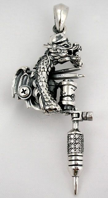 dragon tattoos machine gun pendant. AWESOME CARVING BY MASTER SILVERSMITH.